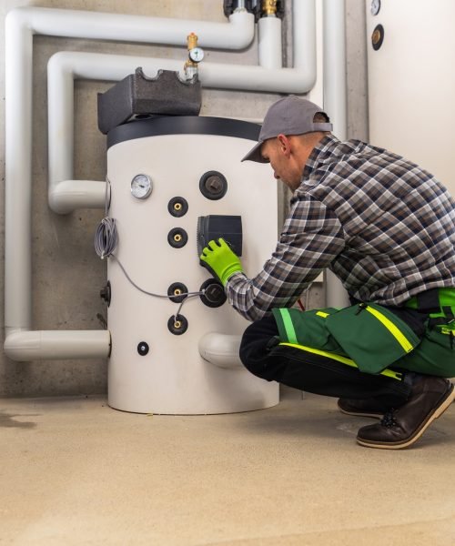 HVAC Technician Finishing Installation of Gas Heating Boiler