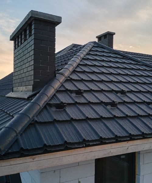 Snow guard for safety in winter on house roof top covered with steel shingles.